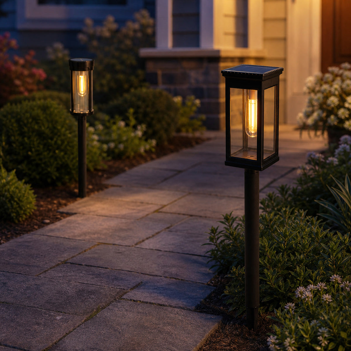 Square and round solar Edison pathway lights glowing beside a front walkway