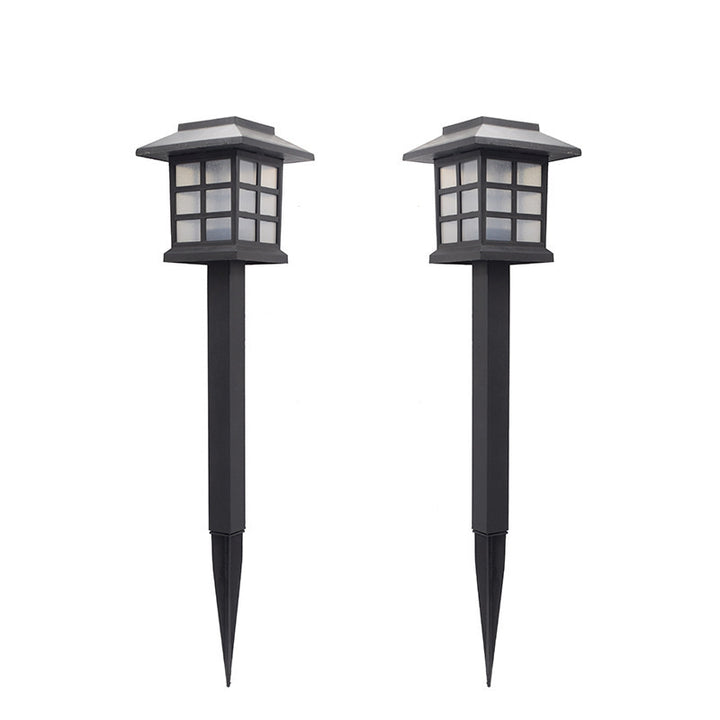 Pair of solar cottage pathway lights on a white background