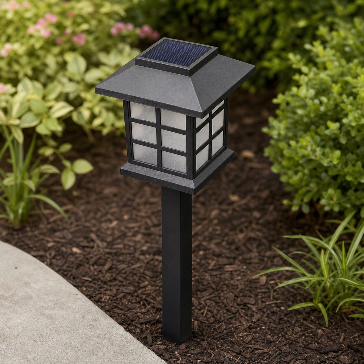 Close view of a black solar cottage pathway light and its roof-mounted solar panel