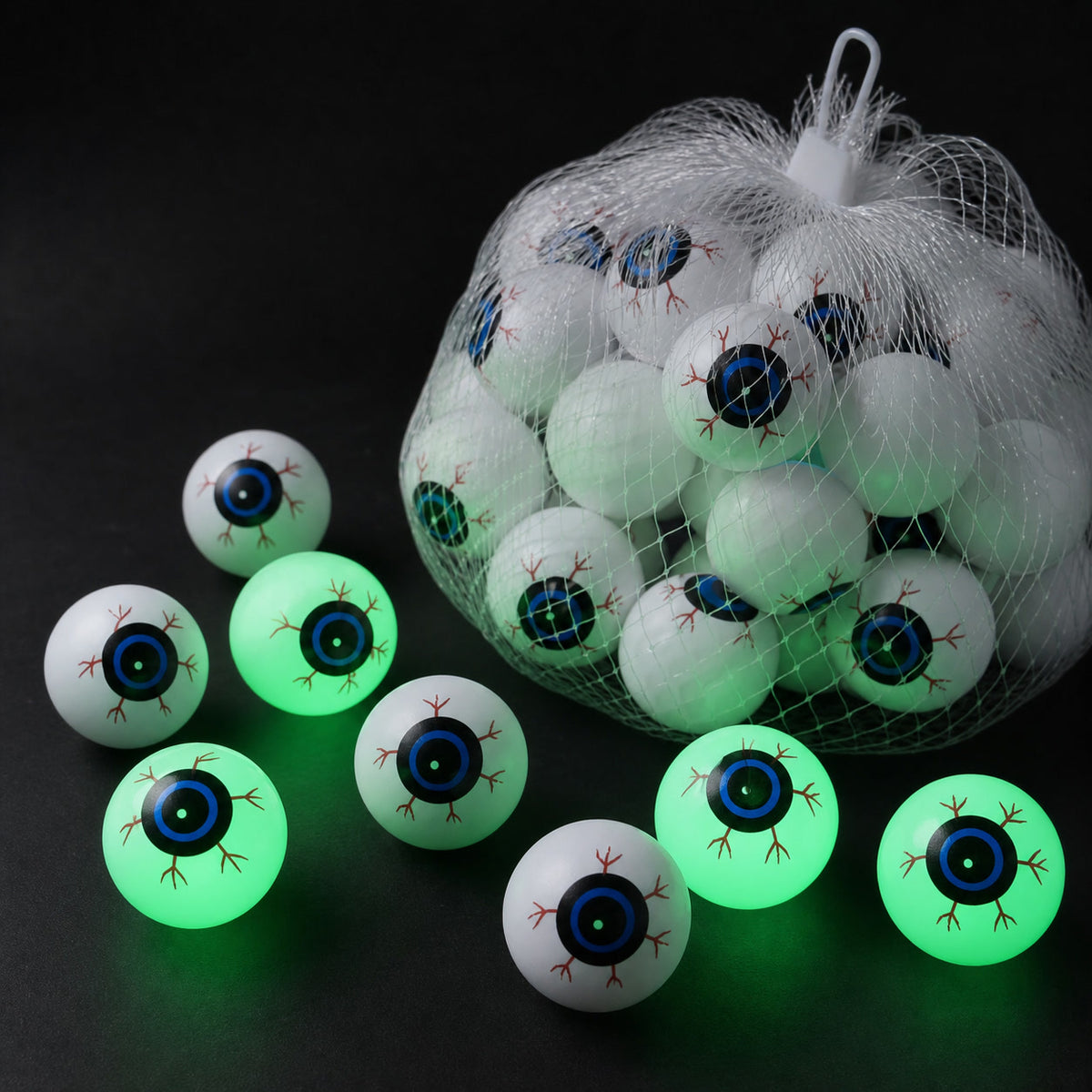 Green-glow Halloween eyeball decorations with a white mesh storage bag