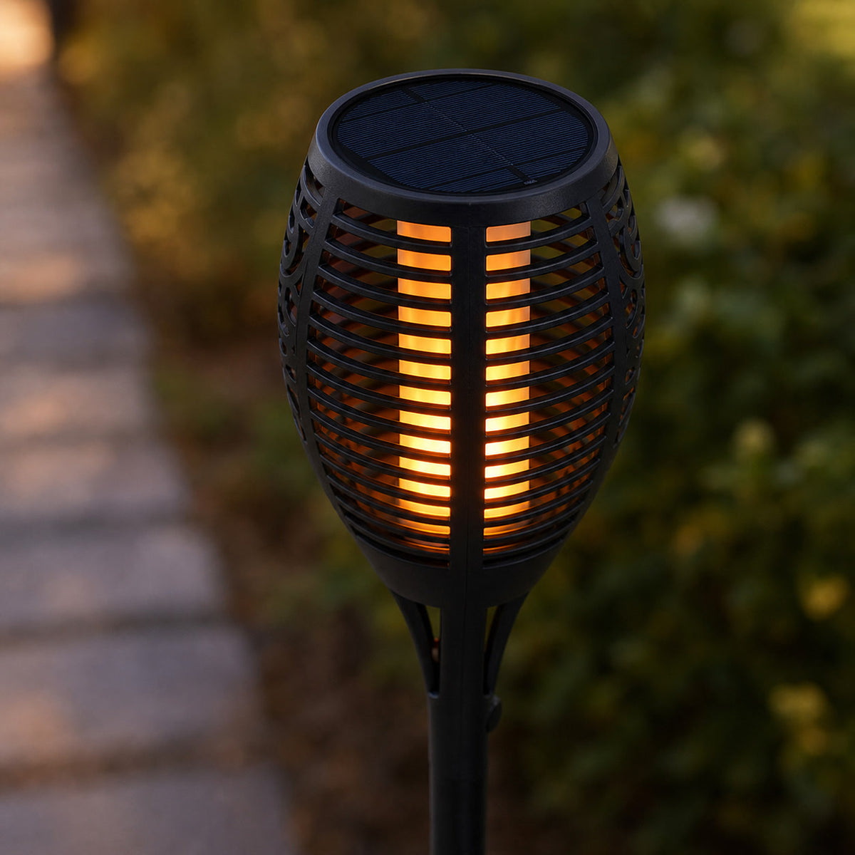 Close view of a ribbed solar torch head with an amber LED flame effect